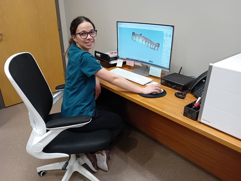 Dental professional viewing digital scan of teeth on a computer