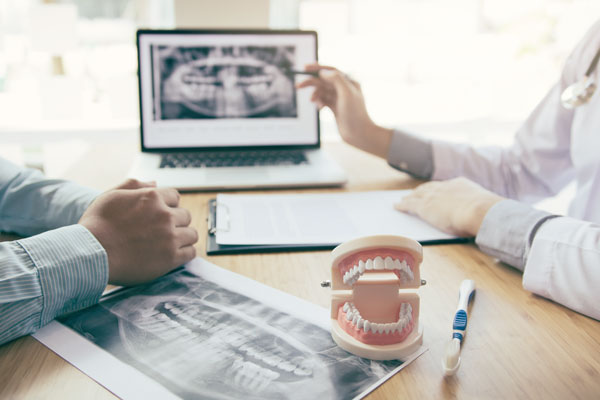 Dental professional showing a patient x-rays