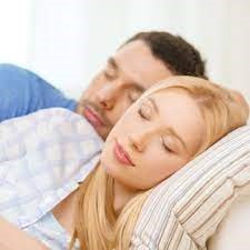 Couple asleep in bed