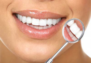 Bright white smile with reflection of teeth in dental mirror
